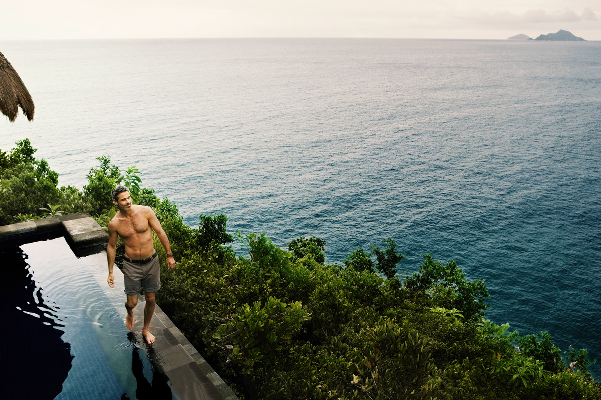 man_walking_next_pool_oceanview